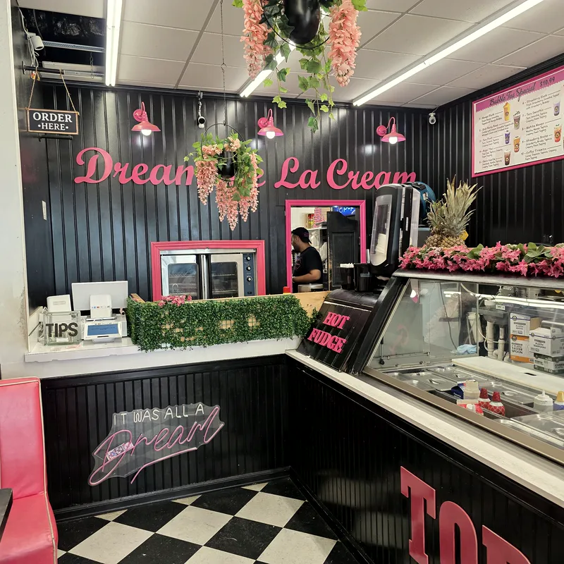 The counter: black beadboard, pink Dream the La Cream letters, pink lamps and the HOT FUDGE sign on the case